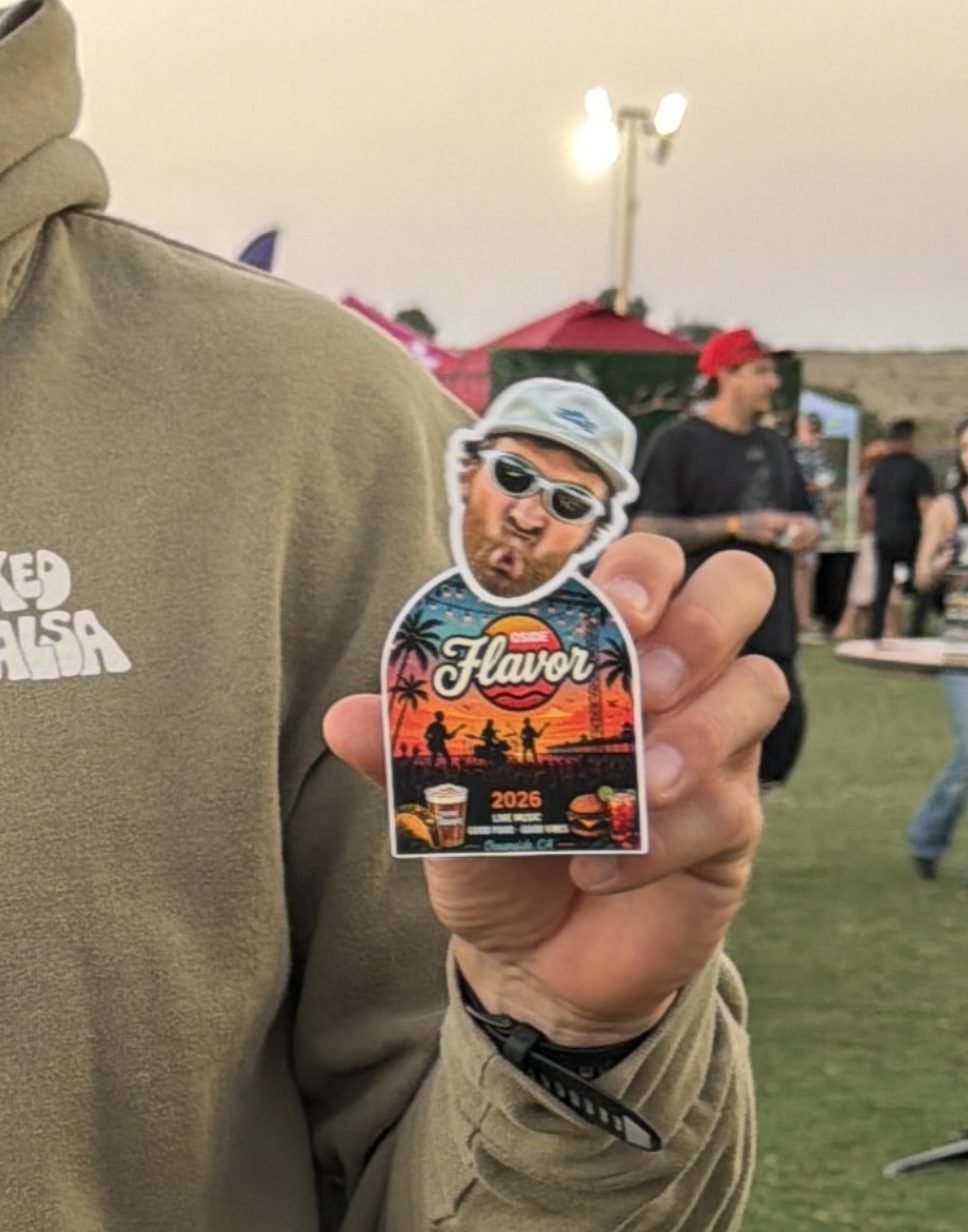 Guest at an outdoor festival holding his personalized TinyTwin bobblehead